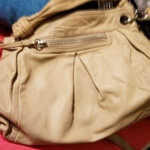 A  beige color coach purse